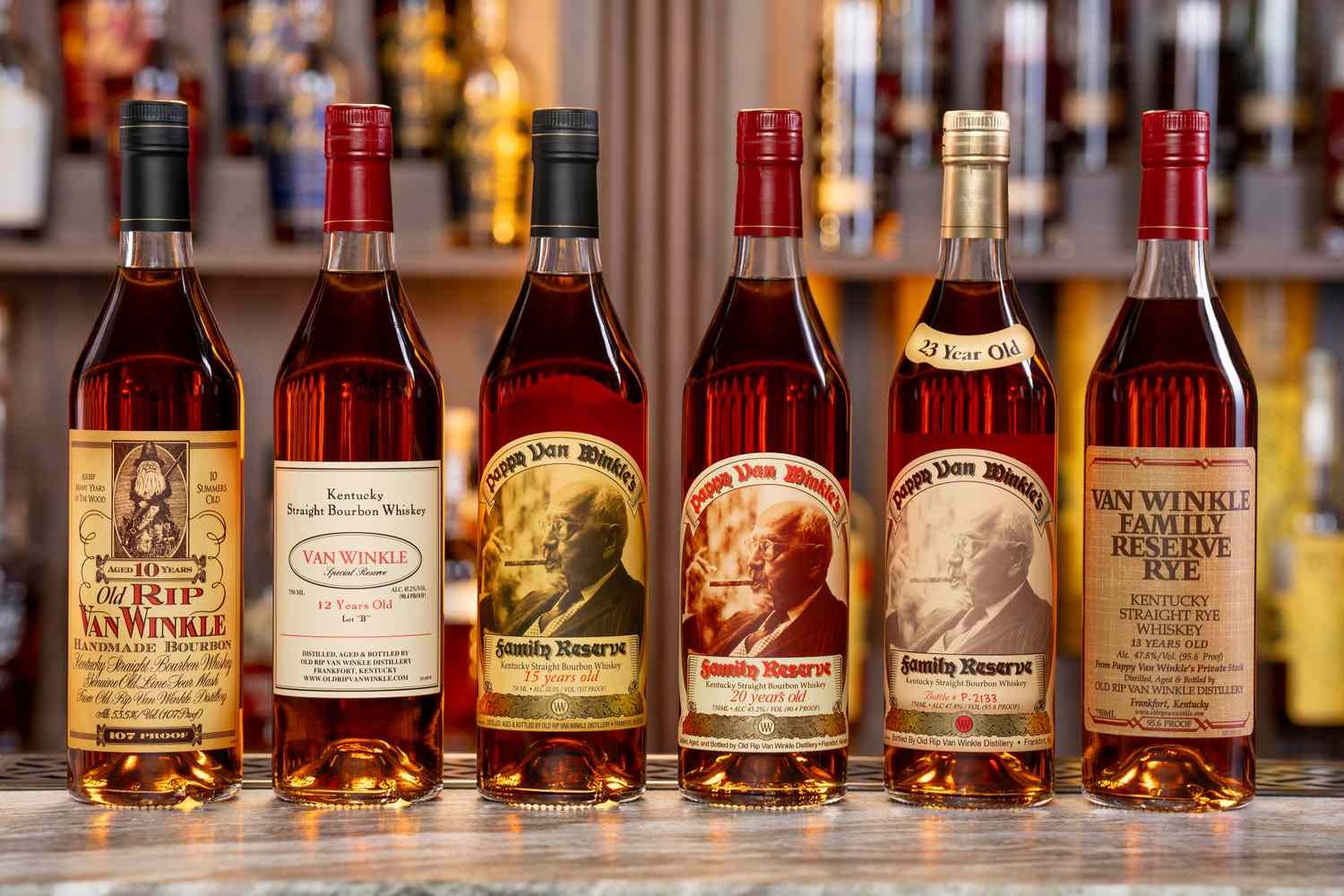 Van Winkle and Pappy Van Winkle bottles arranged on a warm bar top
